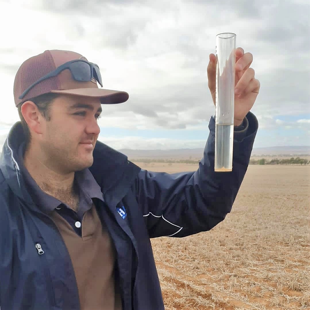 Hart regional intern, Declan Anderson, measuing rainfall at Hart